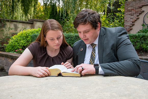 Students reading scriptures on campus.
