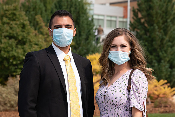 Students smiling at the camera on BYU-Idaho campus after church on a Sunday. Wearing face masks due to the COVID-19 pandemic.