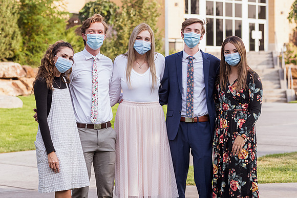Students stay safe wearing masks and social distancing in their sunday best.