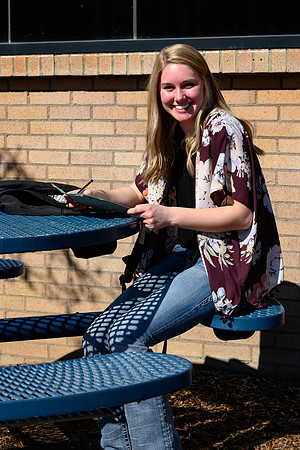 Students studying outside on the first warmer day of the year.