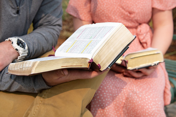 Students reading scriptures on campus.
