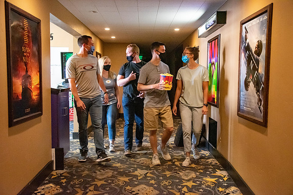 Students at a local movie theater wearing face masks.