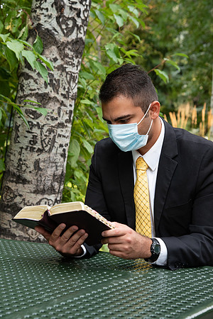 Chris Rodriguez studying his scriptures in the gardens at BYU-Idaho.