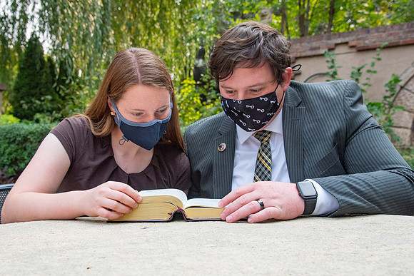 Students reading scriptures on campus.