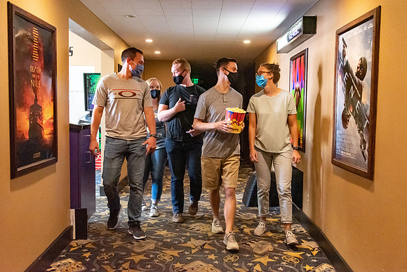 Students at a local movie theater wearing face masks.