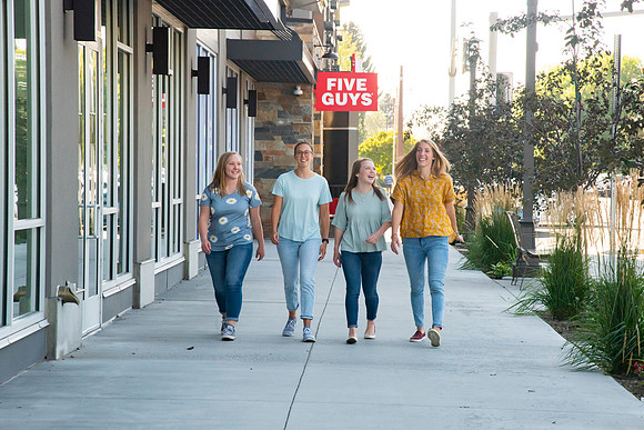 Students walking down the streets of Rexburg with roommates.