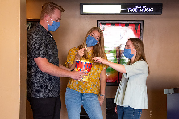 Students at a local movie theater wearing face masks.
