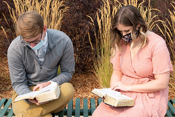 Students reading scriptures on campus.
