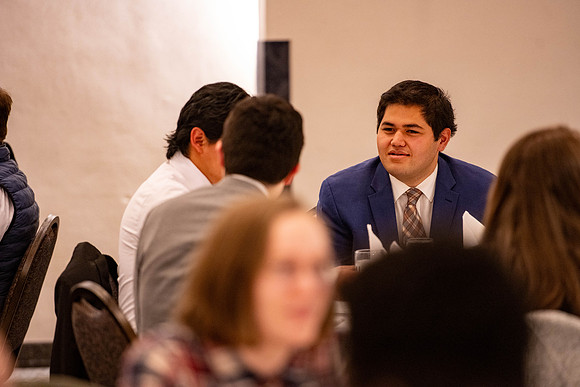 Students gather for a formal dinner, to celebrate a semester of success.