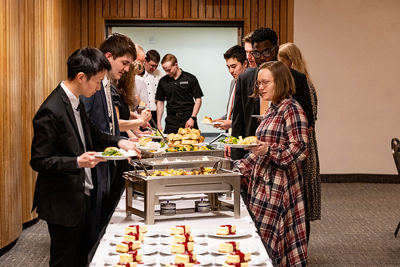 Students gather for a formal dinner, to celebrate a semester of success.