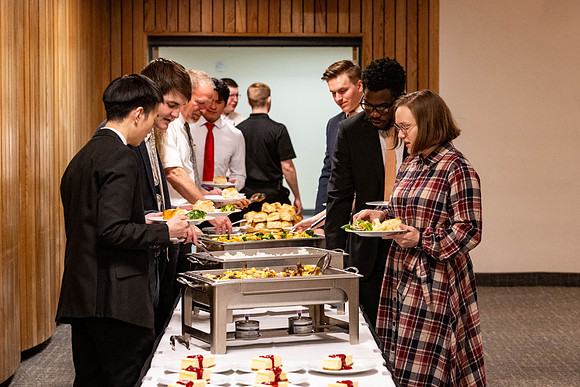 Students gather for a formal dinner, to celebrate a semester of success.