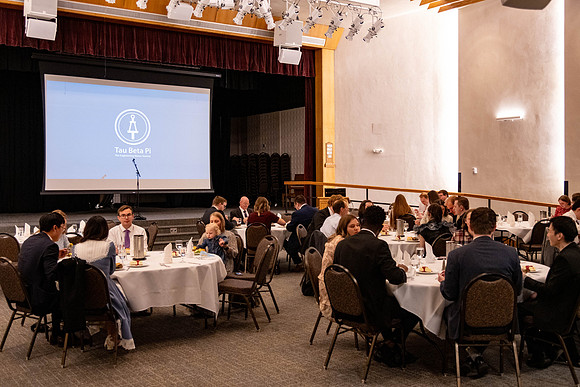 Students gather for a formal dinner, to celebrate a semester of success.
