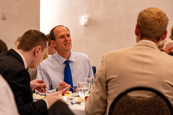 Students gather for a formal dinner, to celebrate a semester of success.