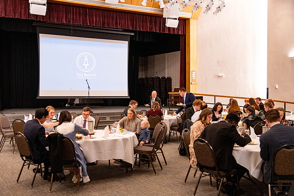 Students gather for a formal dinner, to celebrate a semester of success.
