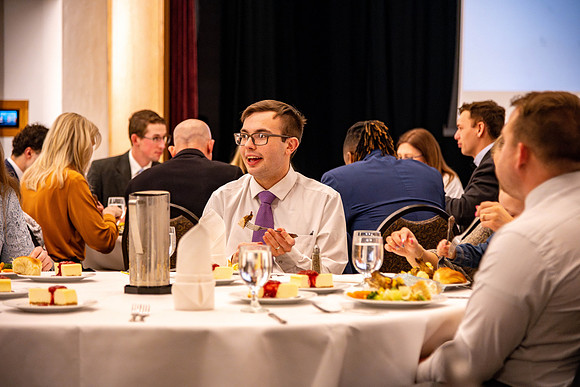 Students gather for a formal dinner, to celebrate a semester of success.