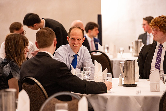 Students gather for a formal dinner, to celebrate a semester of success.
