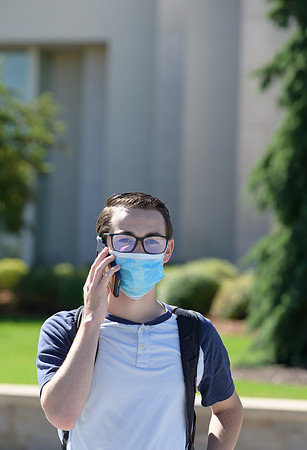Student volunteers show the way to stay safe during this COVID 19 pandemic by social distancing, following pathway arrows and proper wearing of masks .