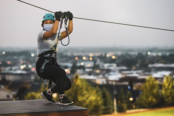 Students navigate the BYU-Idaho ropes course while taking social distancing precautions and wearing masks.