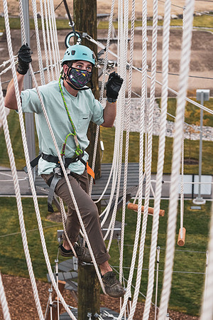 Students navigate the BYU-Idaho ropes course while taking social distancing precautions and wearing masks.