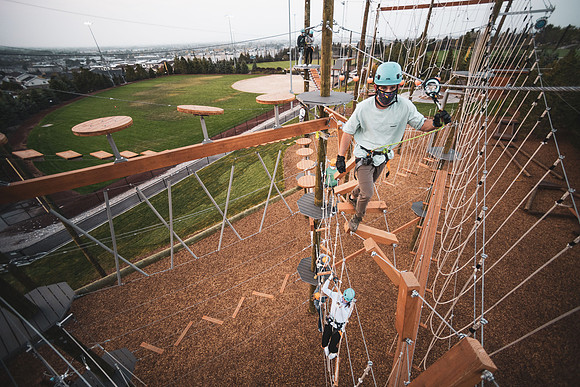 Students navigate the BYU-Idaho ropes course while taking social distancing precautions and wearing masks.