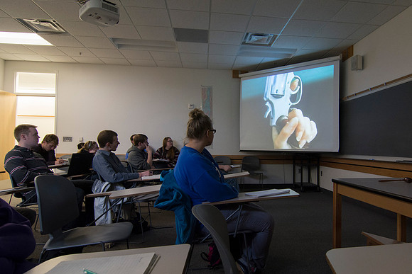 Students watch a video in Sister Jenson's Criminology class entitled, "Packing Heat," about women using weapons.