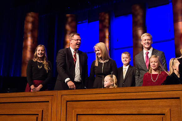 Clark G. Gilbert and his family on the podium after todays devotional. Taken by Erik Hill.