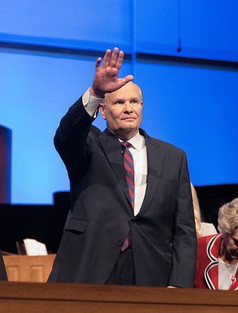 Elder Dale G. Renlund, of the Quorum of the Twelve Apostles, has the audience to be seated.