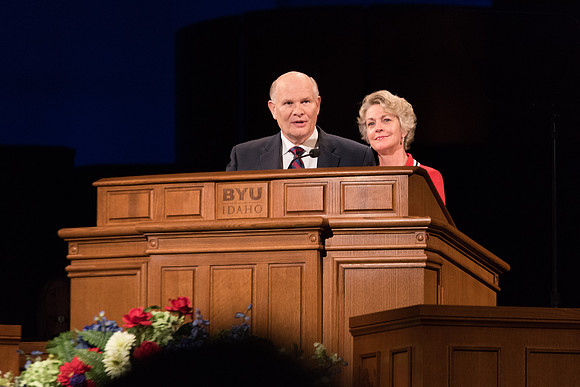 Elder Renlund and Sister Renlund stand together and speak at BYUI devotional. Photo by Garrett Blanchard