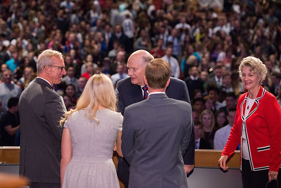 Elder and Sister Renlund shake hands at the end of devotional.