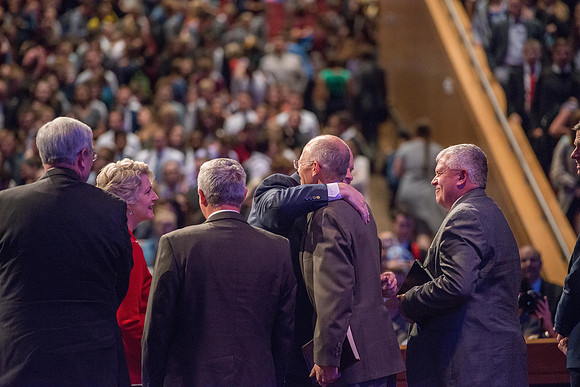 Elder and Sister Renlund shake hands at the end of devotional.
