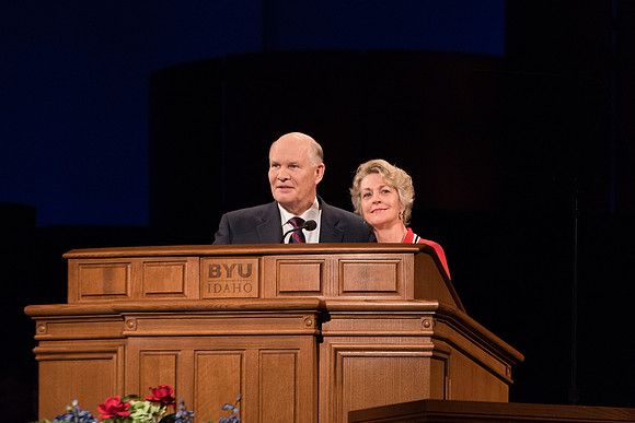 Elder Renlund and Sister Renlund stand together and speak at BYUI devotional. Photo by Garrett Blanchard