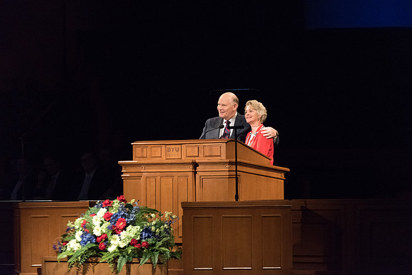 Elder Renlund and Sister Renlund stand together and speak at BYUI devotional. Photo by Garrett Blanchard