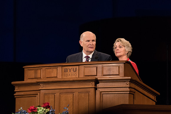 Elder Renlund and Sister Renlund stand together and speak at BYUI devotional. Photo by Garrett Blanchard