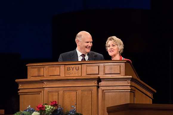 Elder Renlund and Sister Renlund stand together and speak at BYUI devotional. Photo by Garrett Blanchard
