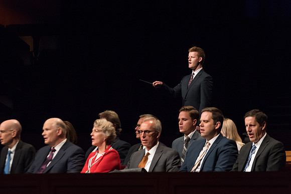 A student conducts the music at Devotional. 2017