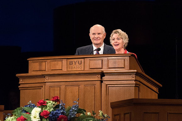 Elder Renlund and Sister Renlund stand together and speak at BYUI devotional. Photo by Garrett Blanchard
