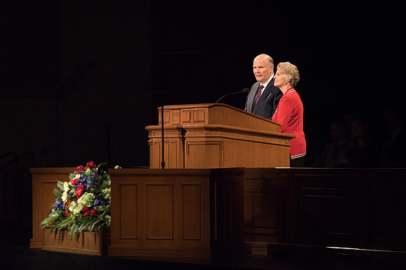 Elder Renlund and Sister Renlund stand together and speak at BYUI devotional. Photo by Garrett Blanchard