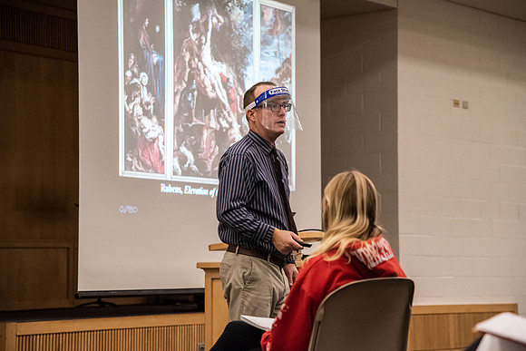 Professor Stratford teaching his humanities class wearing his face shield during Covid-19.