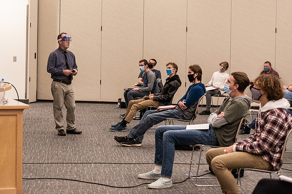 Professor Stratford teaching his humanities class wearing his face shield during Covid-19.