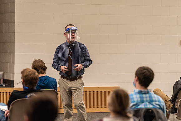 Professor Stratford teaching his humanities class wearing his face shield during Covid-19.