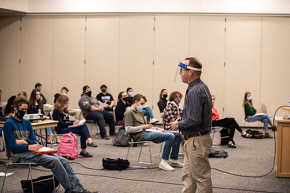 Professor Stratford teaching his humanities class wearing his face shield during Covid-19.