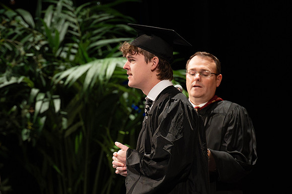 Students graduate from the college of Business and Communication in the I-Center.