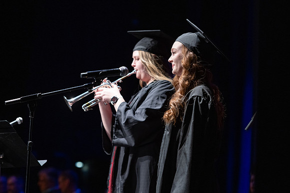 Clara Cranney and Whitney Corpany perform for the Performing and Visual Arts convocation.