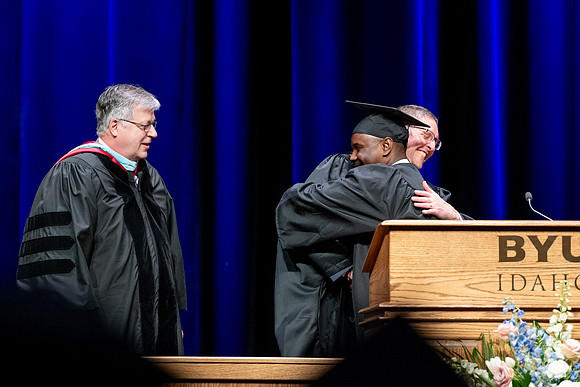Graduates of the Performing and Visual Arts walk across the stage and accept their diplomas.