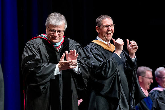 Graduates of the Performing and Visual Arts walk across the stage and accept their diplomas.