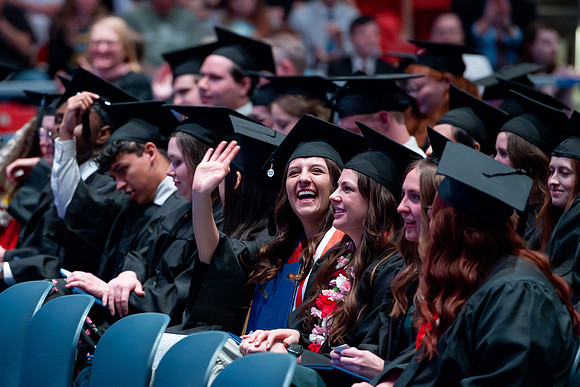 Graduates of the Performing and Visual Arts walk across the stage and accept their diplomas.