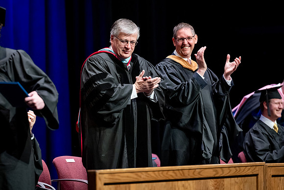 Graduates of the Performing and Visual Arts walk across the stage and accept their diplomas.