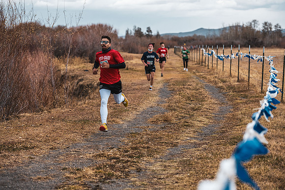 Students compete in the Competitive Sports Cross Country championship on a course at the BYU-Idaho Livestock Center.