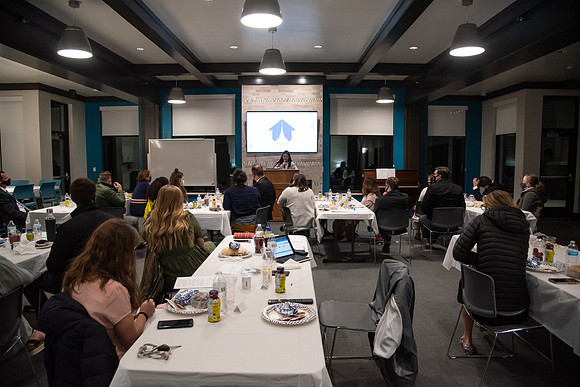 Faculty and Staff of Housing and Student Living gather for an early morning breakfast and an inspirational speaker in the new community center at University Village.