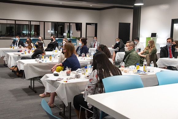 Faculty and Staff of Housing and Student Living gather for an early morning breakfast and an inspirational speaker in the new community center at University Village.